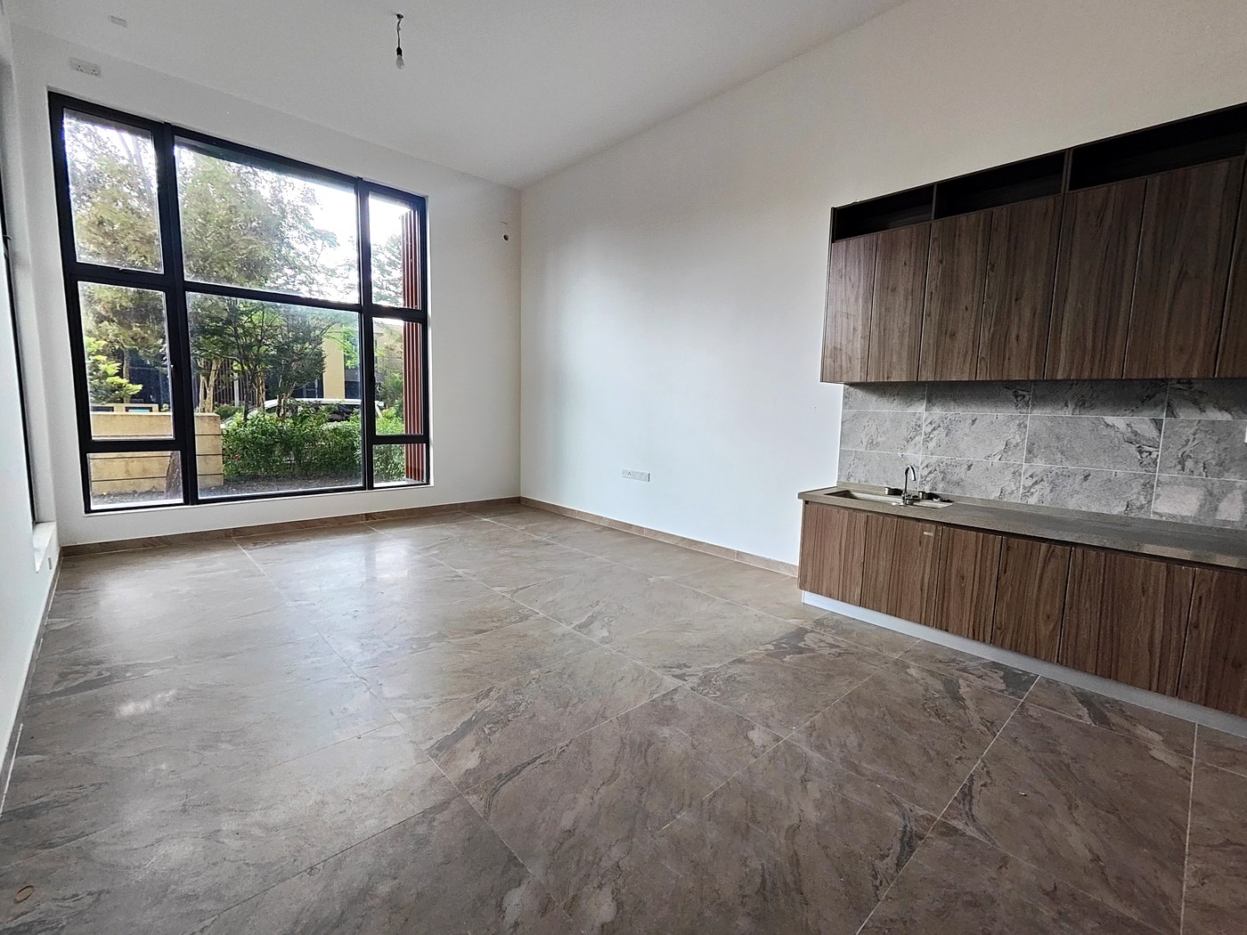 Open-plan kitchen and living room with garden-facing windows